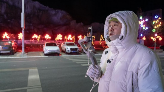 在吉林市阿什哈達(dá)霧凇觀景帶,霧凇播報(bào)員正在直播。新華社記者 李典 攝